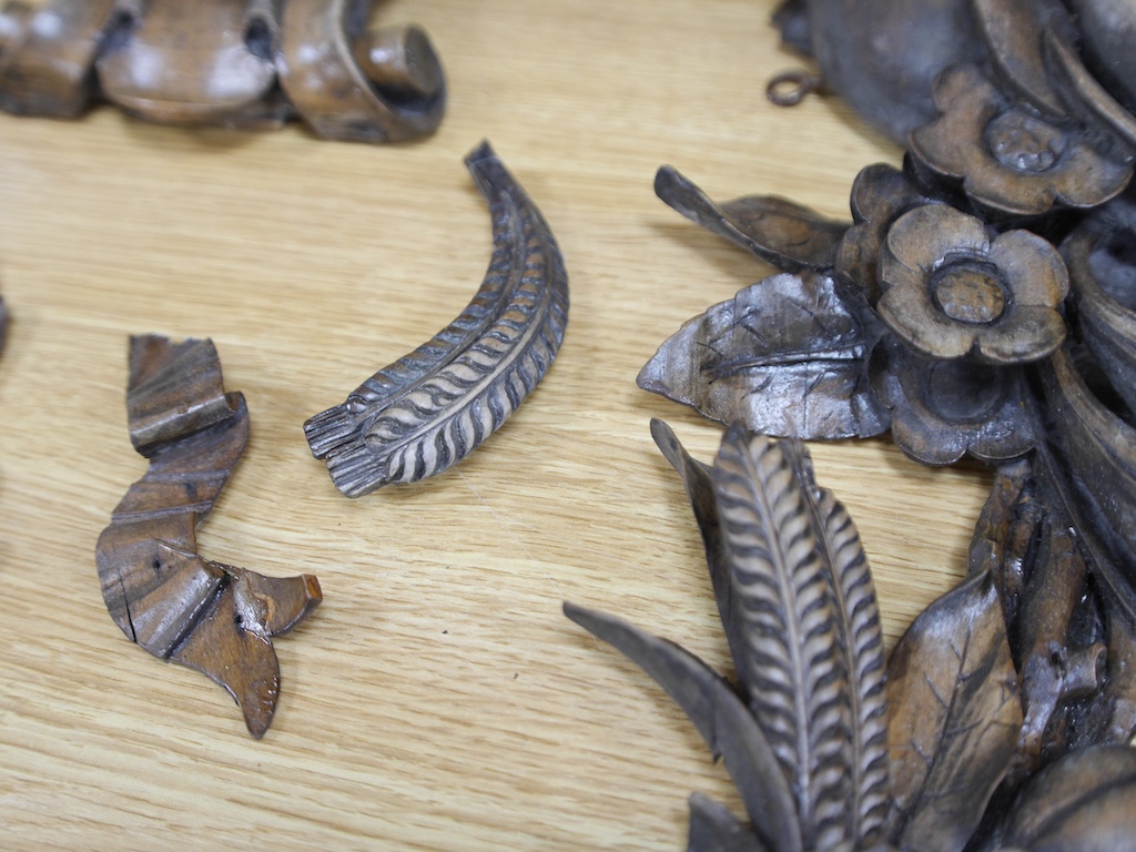 A pair of late 19th/early 20th century carved beech ‘fruit and flower’ wall appliqués and a similar corbel, 70cm long. Condition - fair